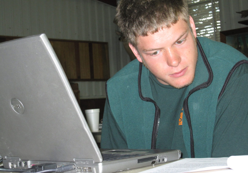 Forestry student working on a laptop